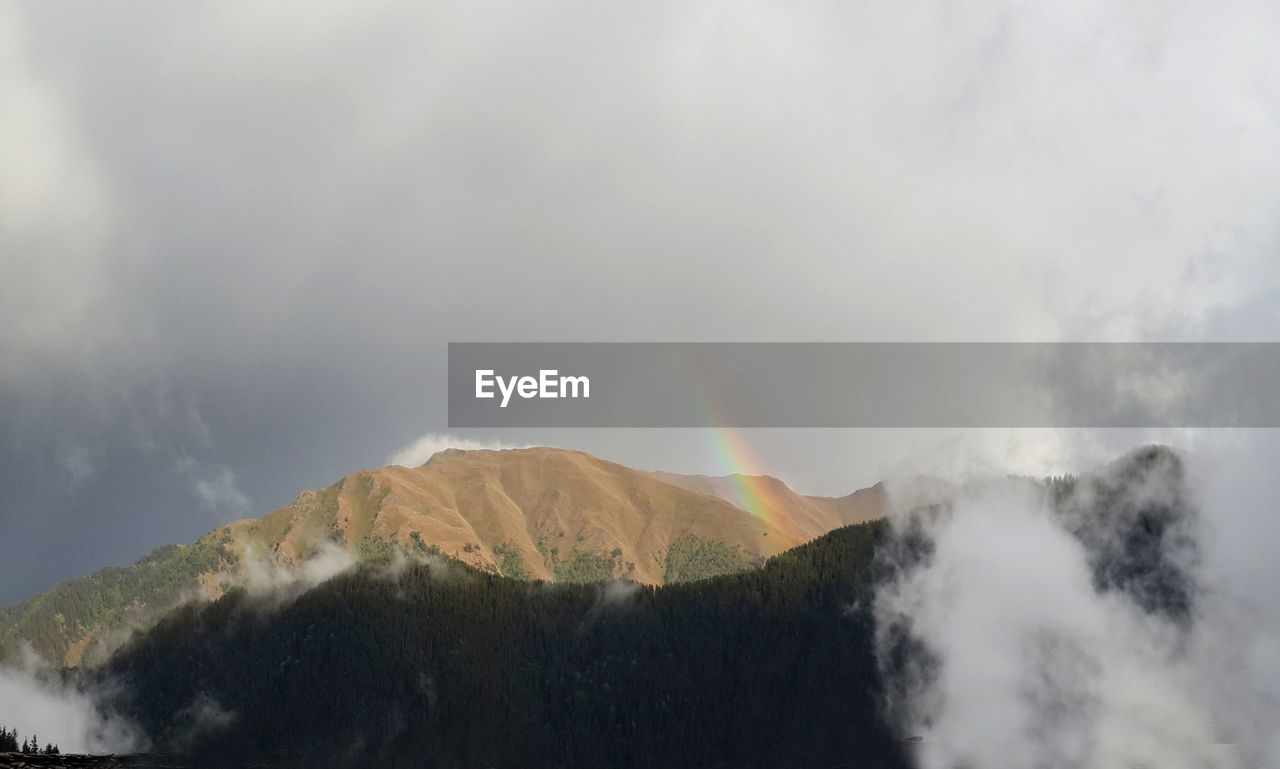 PANORAMIC SHOT OF MOUNTAIN AGAINST SKY