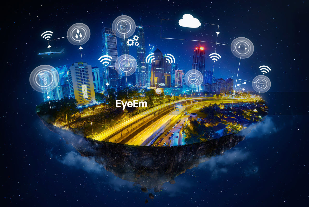 Composite image of illuminated city with various symbols against sky at night