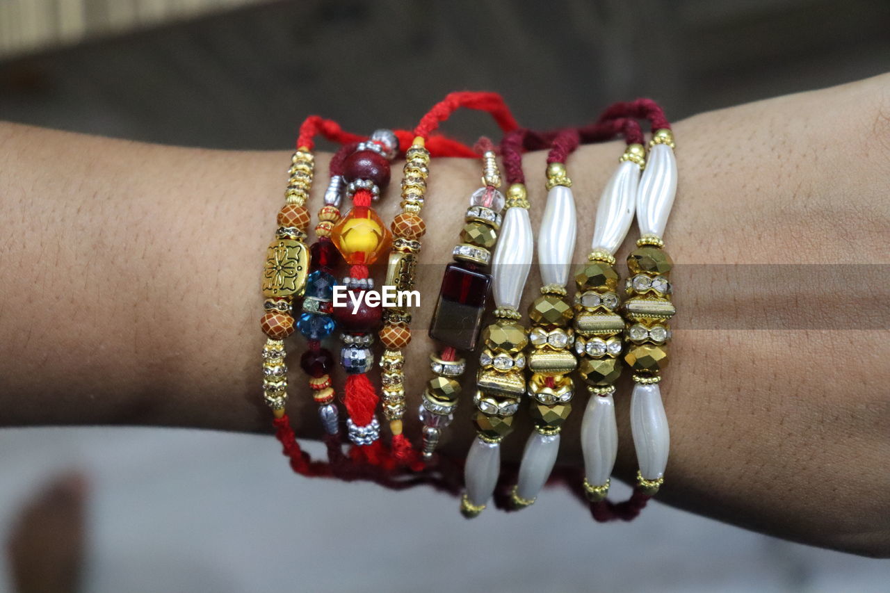 Cropped hand of person with rakhi