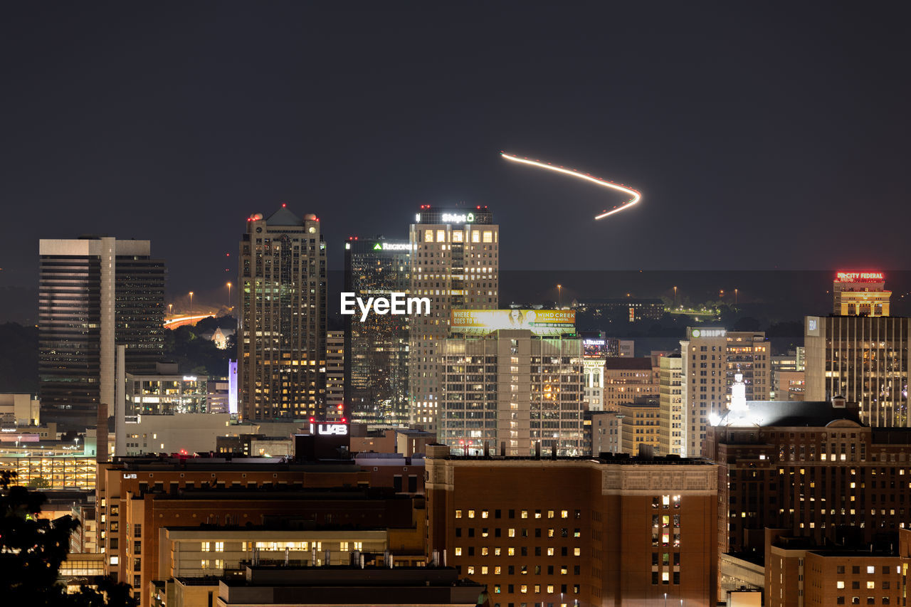 ILLUMINATED BUILDINGS AGAINST SKY AT NIGHT