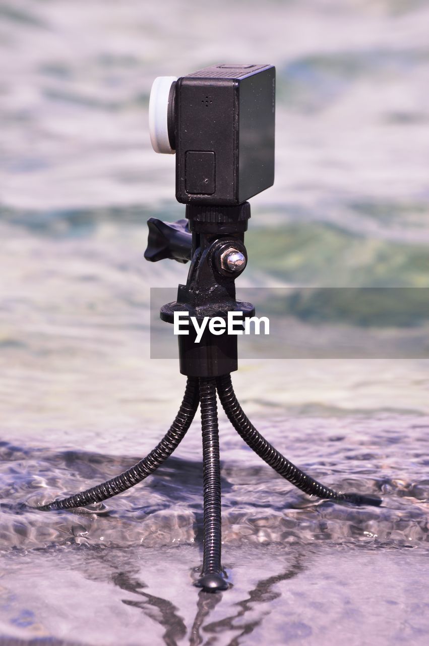 Close-up of camera on sea against sky