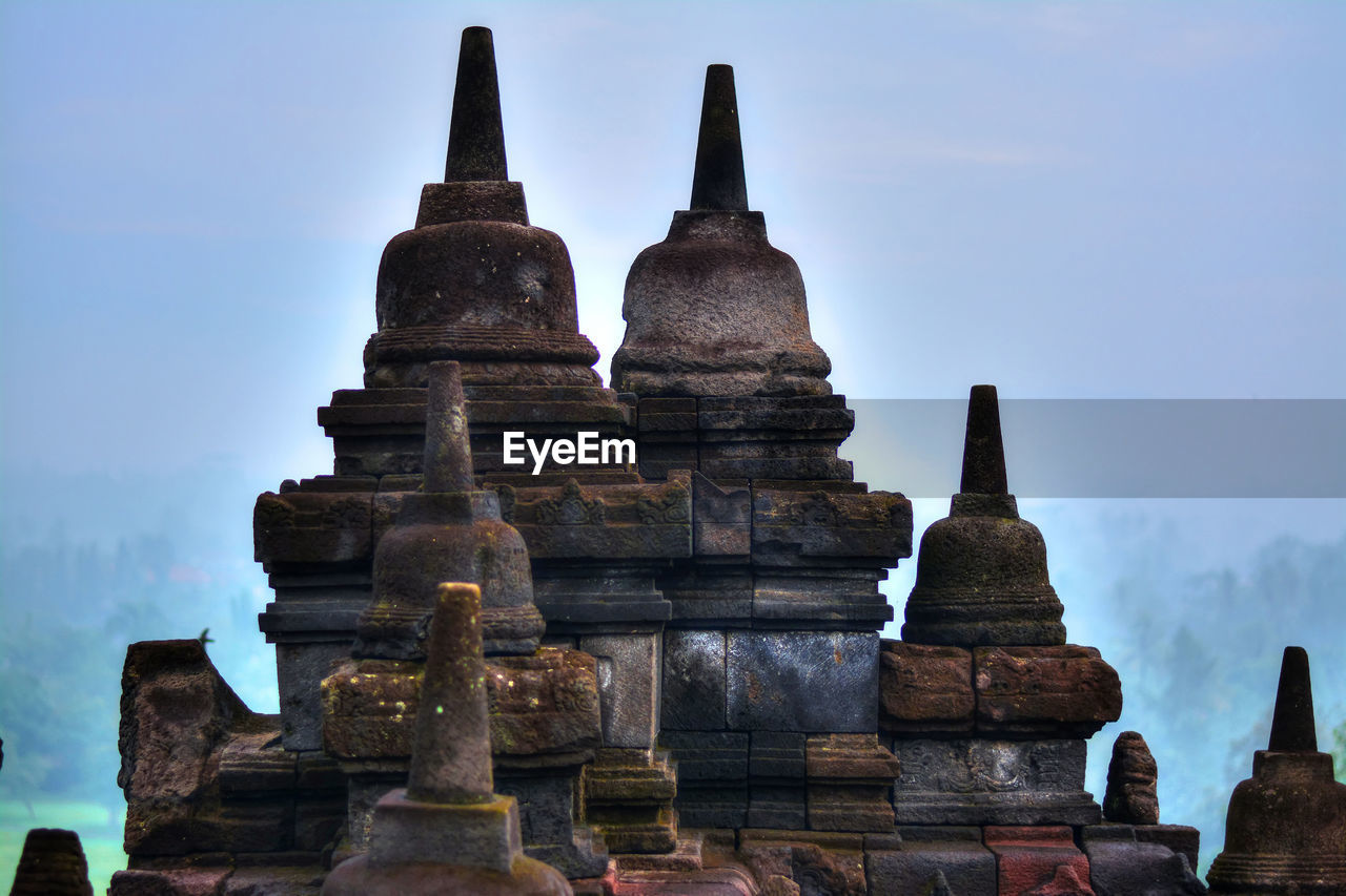 Stupas at borobudur temple against sky