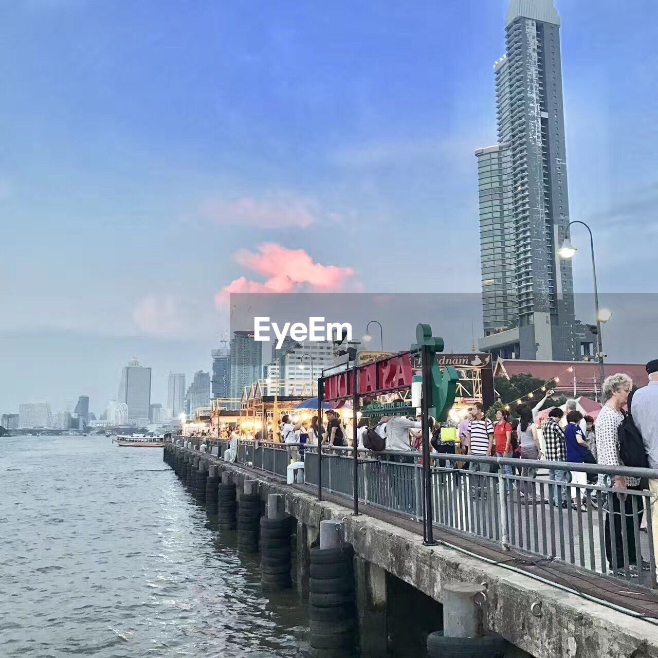 PEOPLE ON BRIDGE OVER RIVER