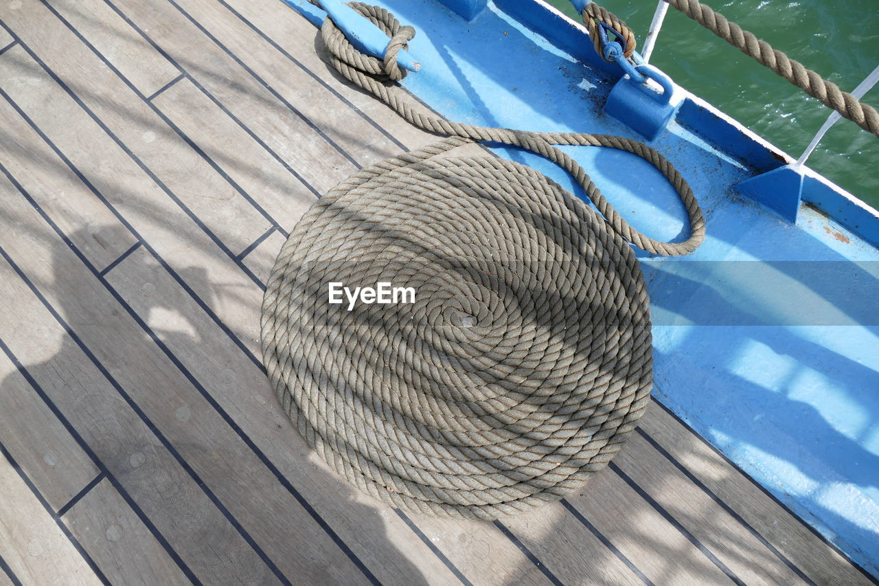 High angle view of rope arranged on boat