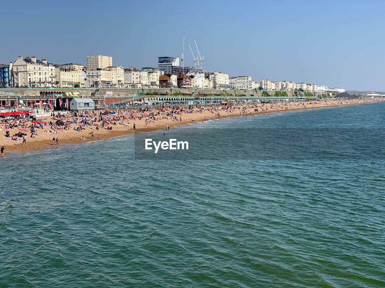 BUILDINGS BY SEA AGAINST CLEAR SKY