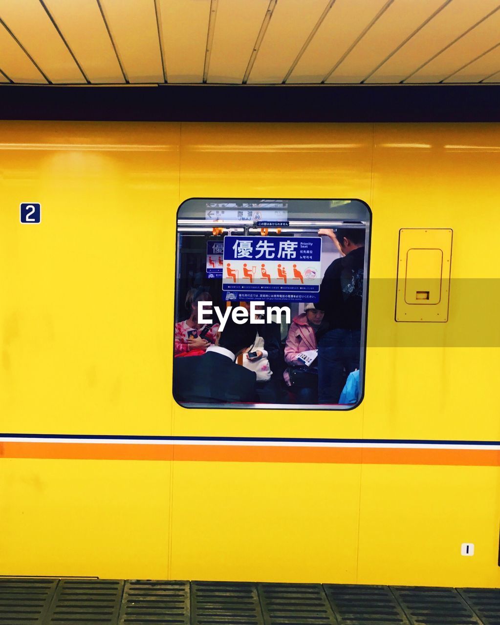 TRAIN ON RAILROAD STATION PLATFORM