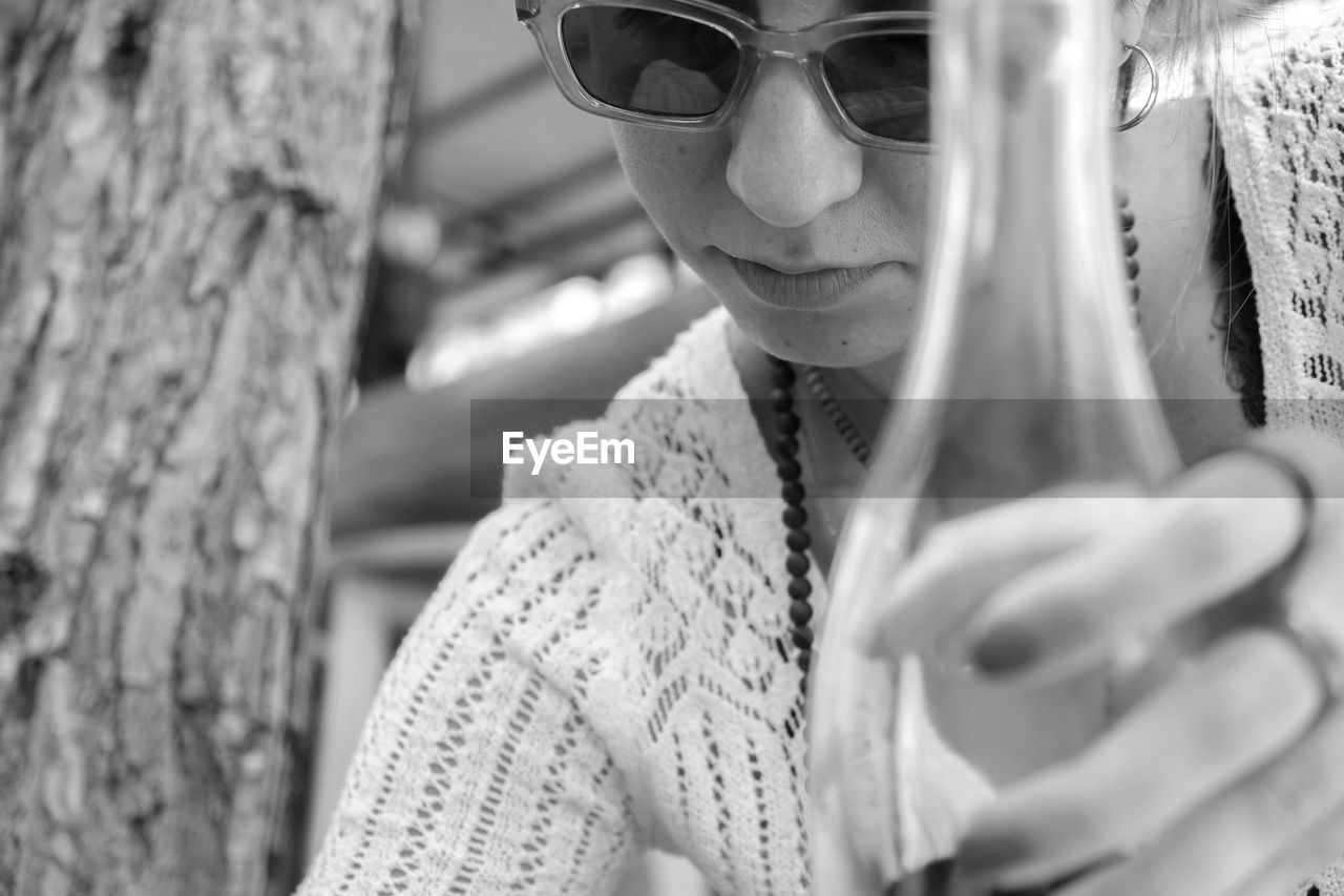 white, one person, glasses, fashion, adult, black and white, sunglasses, women, portrait, monochrome photography, monochrome, young adult, leisure activity, lifestyles, tree trunk, portrait photography, trunk, tree, clothing, black, female, human face, person, day, nature, spring, outdoors, front view, headshot, looking, eyeglasses