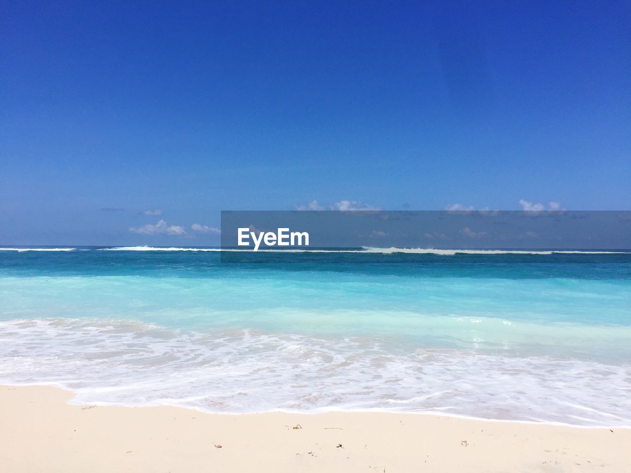 Scenic view of sea against blue sky