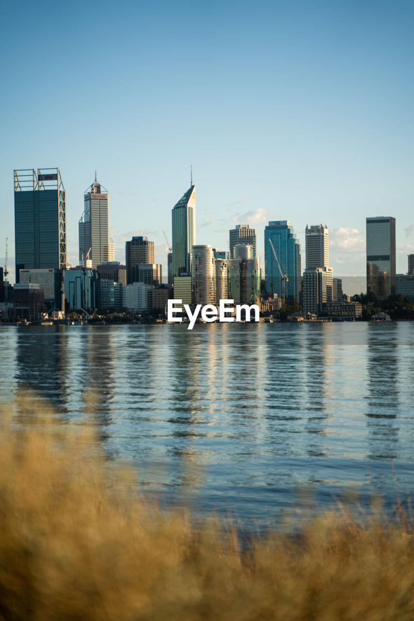 RIVER BY BUILDINGS AGAINST CLEAR SKY