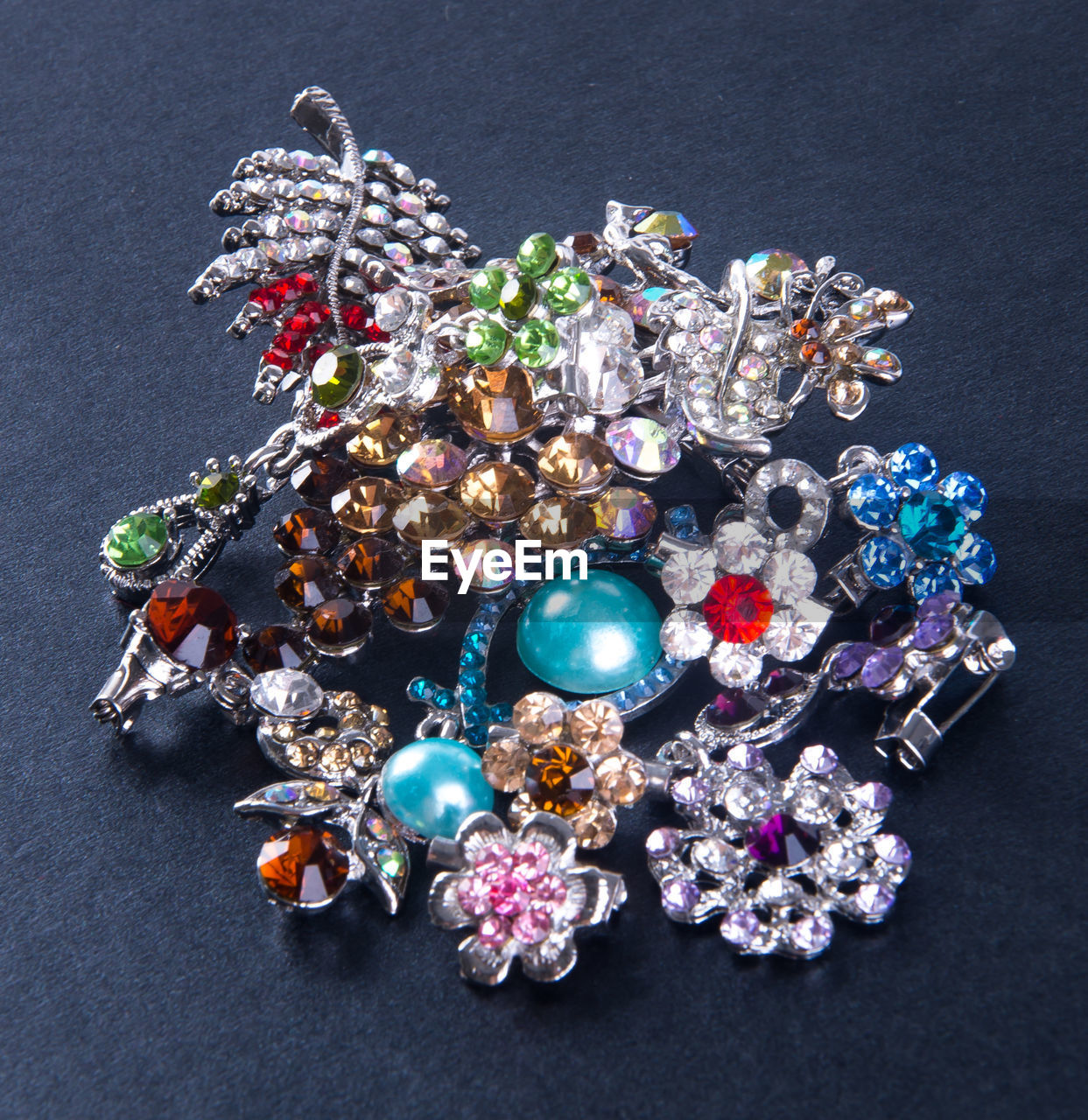 High angle view of diamond brooch on textured table