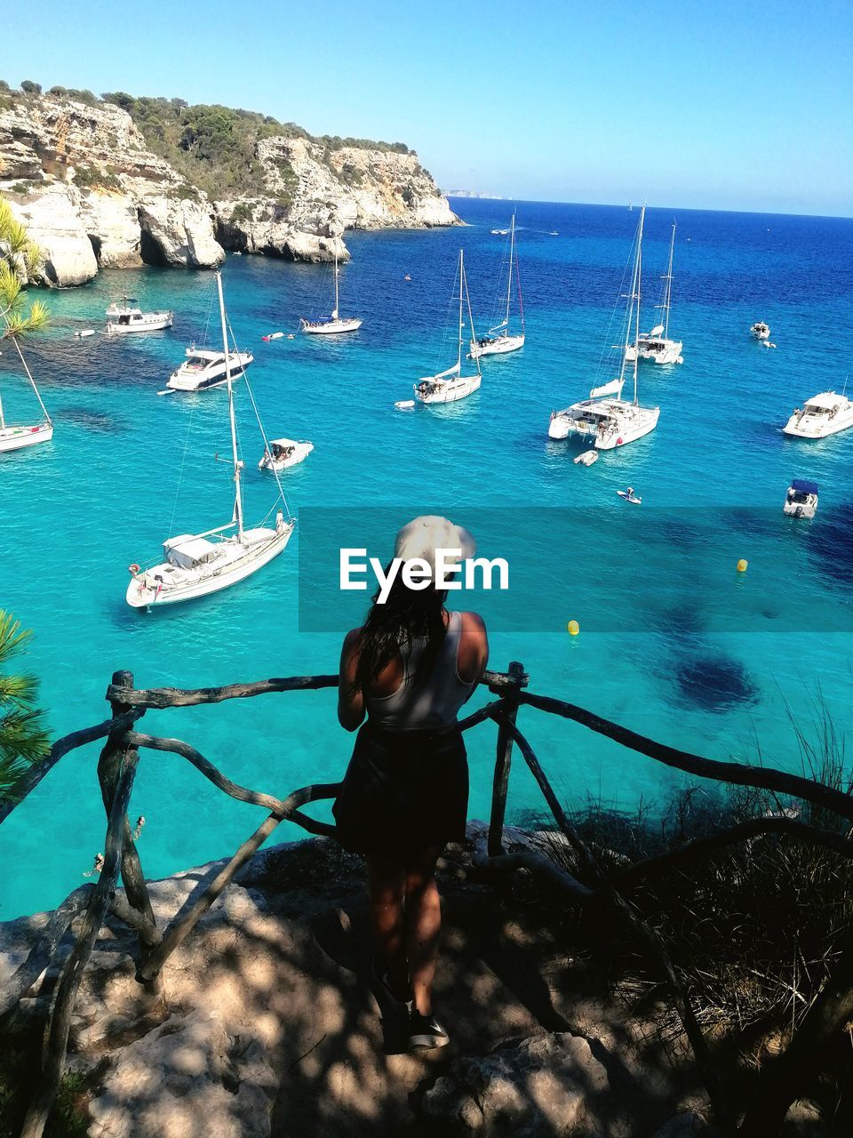 Rear view of woman looking at sea against sky