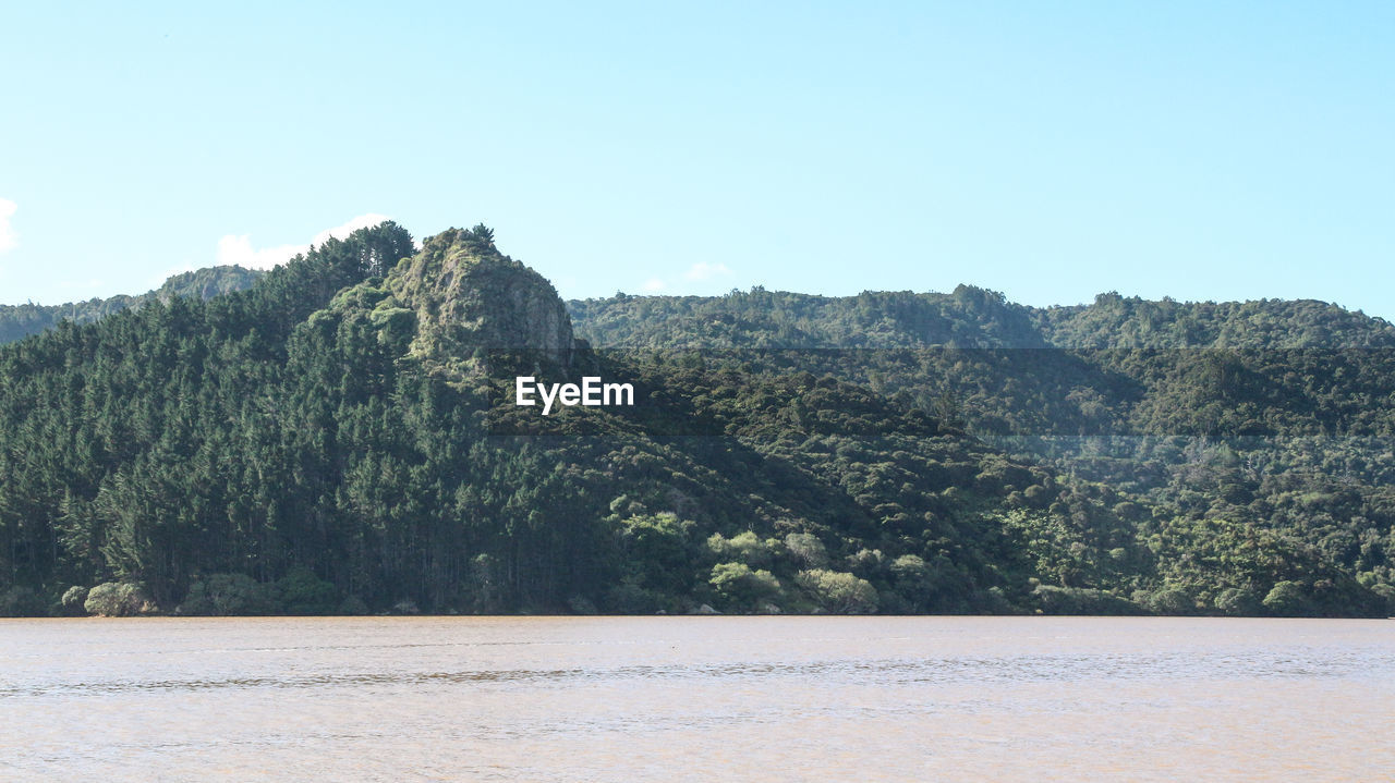 Scenic view of lake and mountains against clear sky