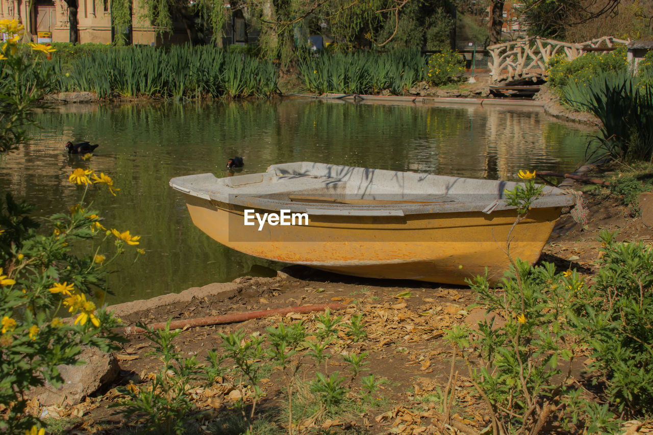 BOATS MOORED ON RIVERBANK