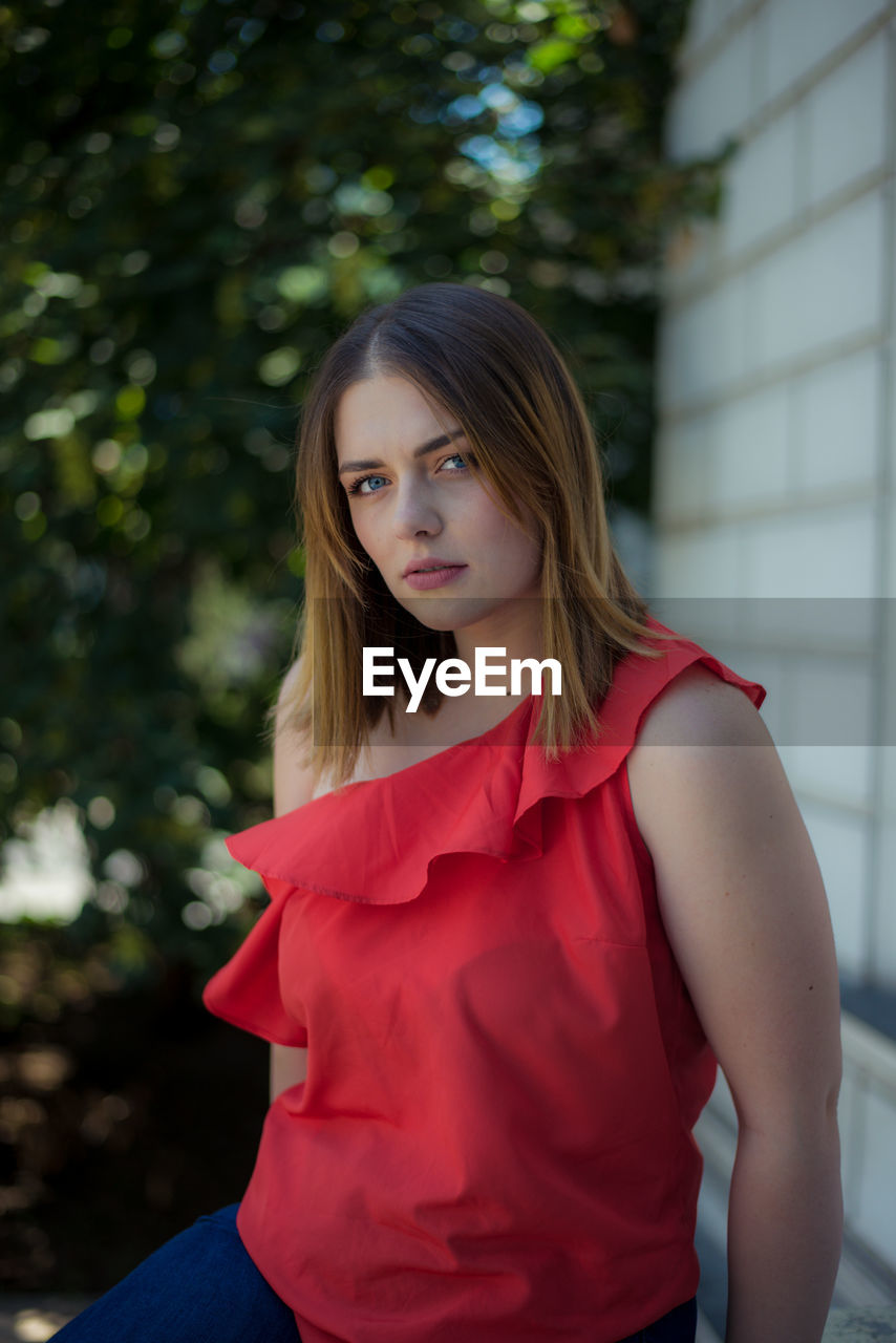 Portrait of beautiful young woman standing outdoors