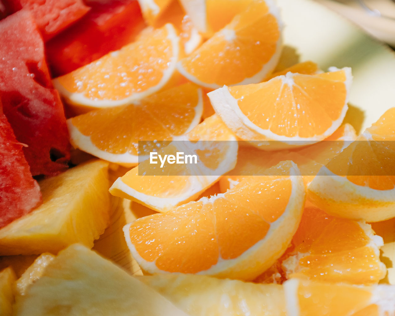 Full frame shot of fresh oranges, watermelon and pineapple slices
