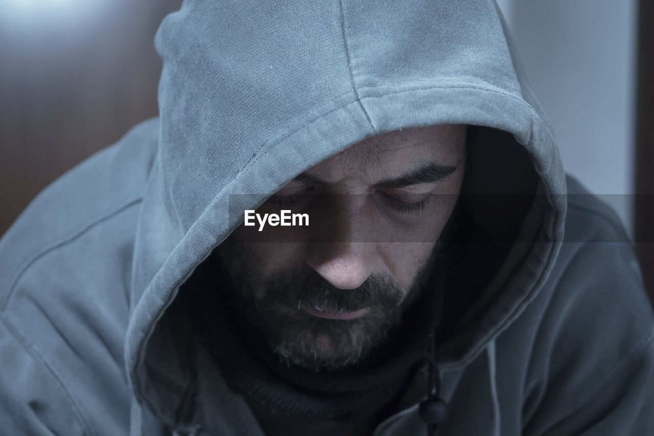 Close-up of man wearing hooded shirt