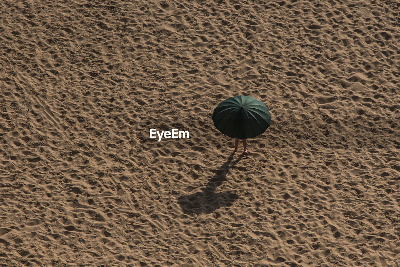 HIGH ANGLE VIEW OF FOOTPRINT ON BEACH