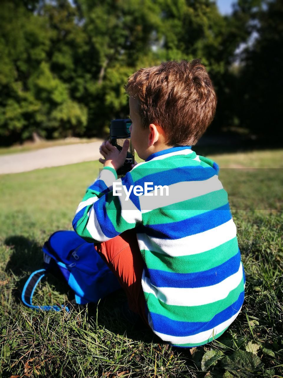 Boy sitting on field