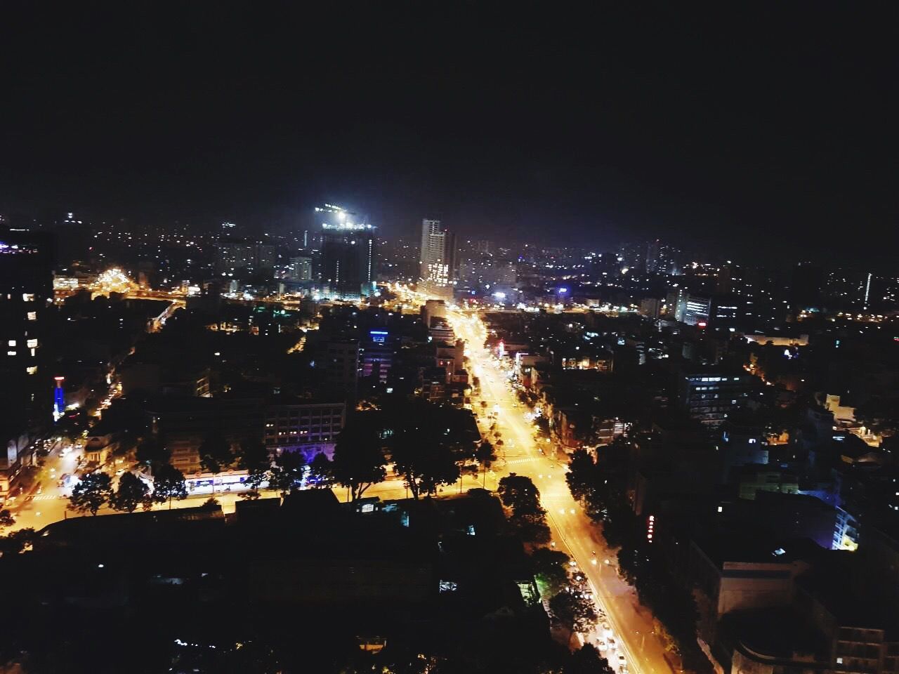 ILLUMINATED CITYSCAPE AGAINST SKY