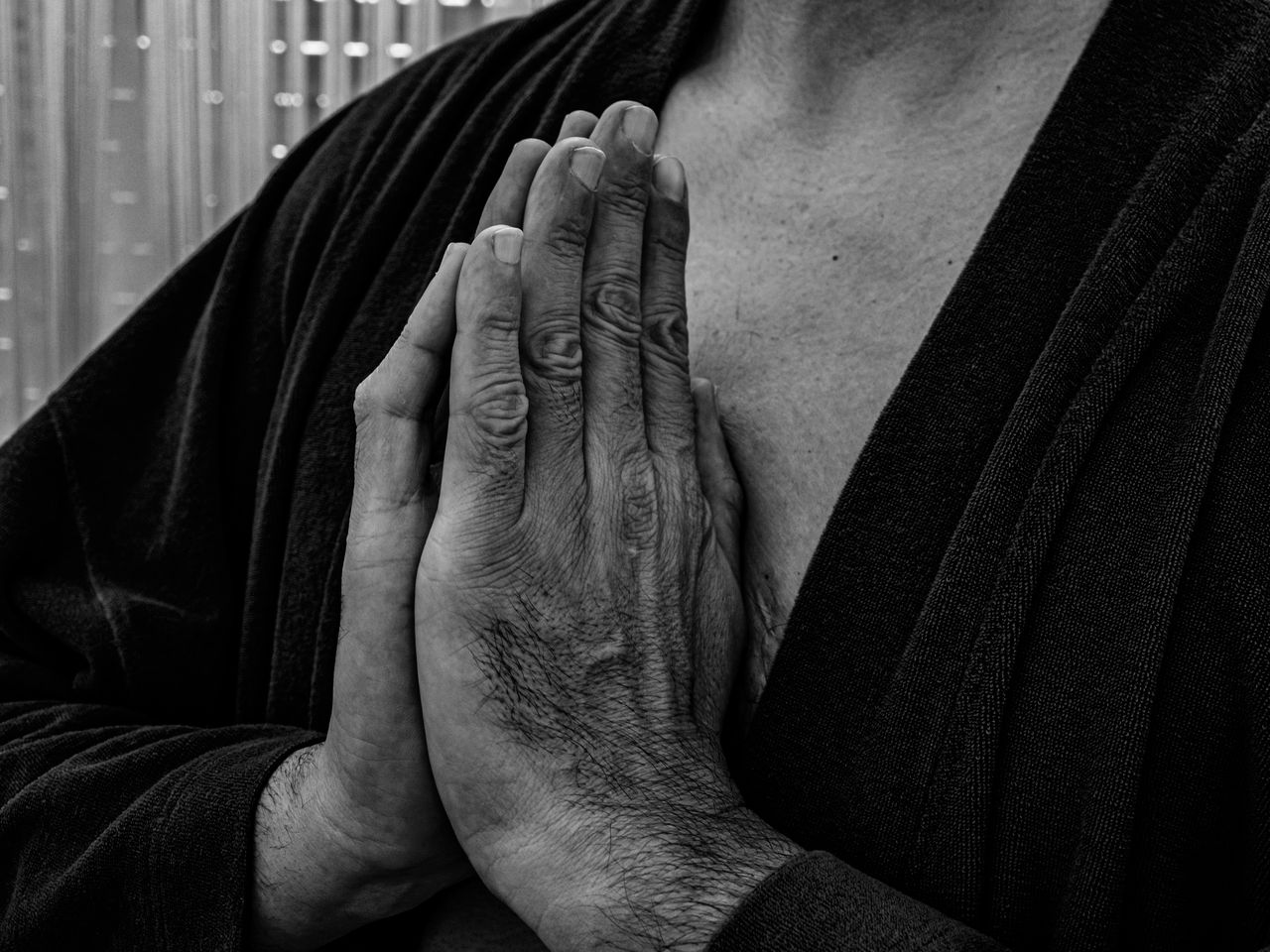 Midsection of man with hands clasped