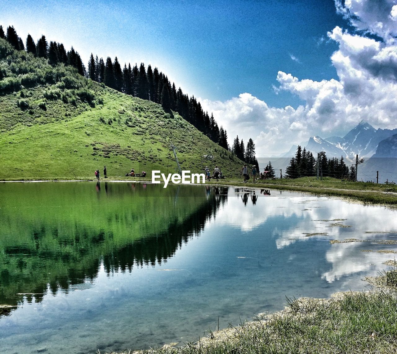 SCENIC VIEW OF LAKE AGAINST CLOUDY SKY