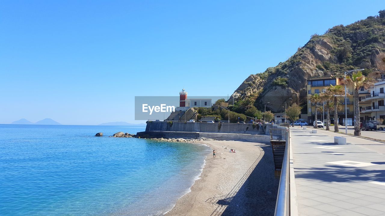 Panoramic view of sea against clear blue sky