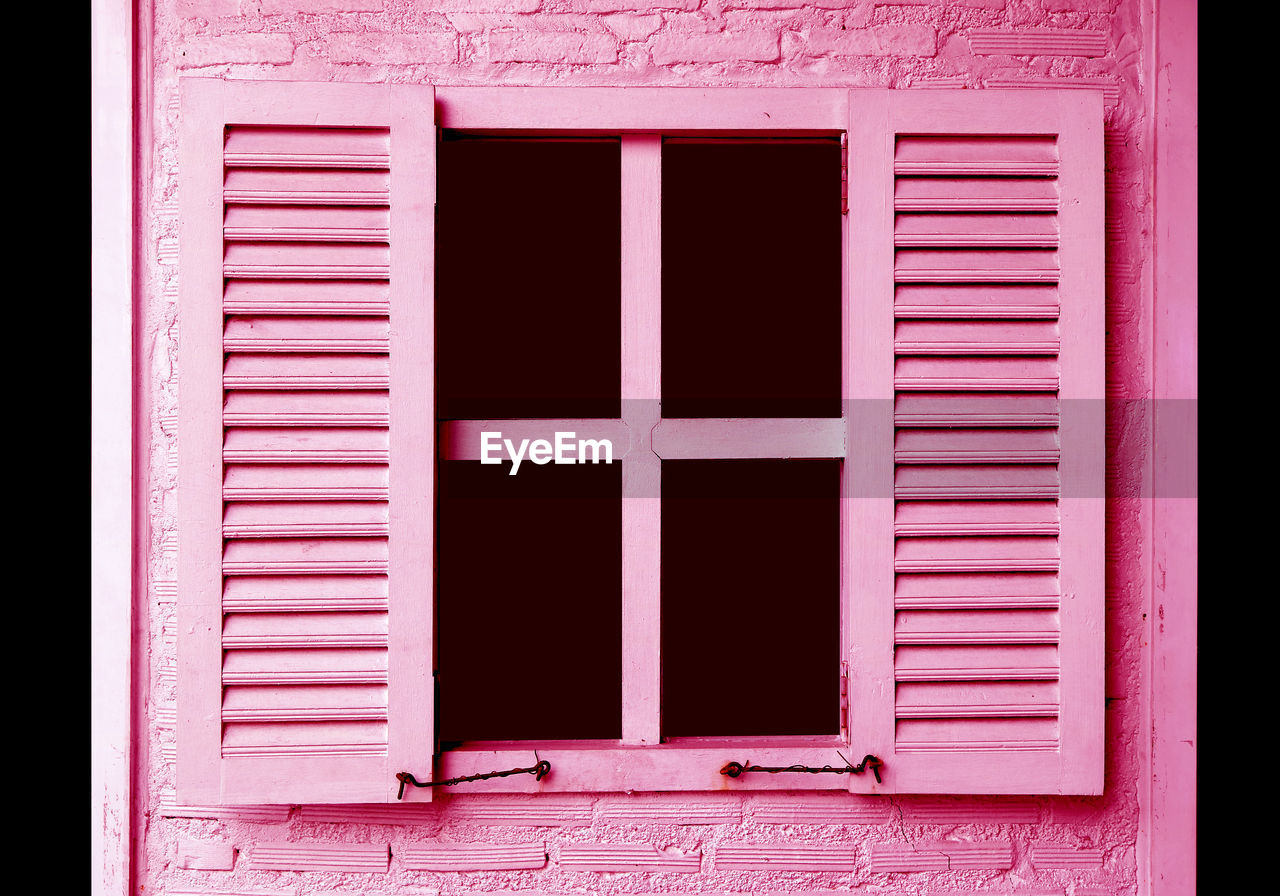 CLOSE-UP OF PINK WINDOW ON BUILDING