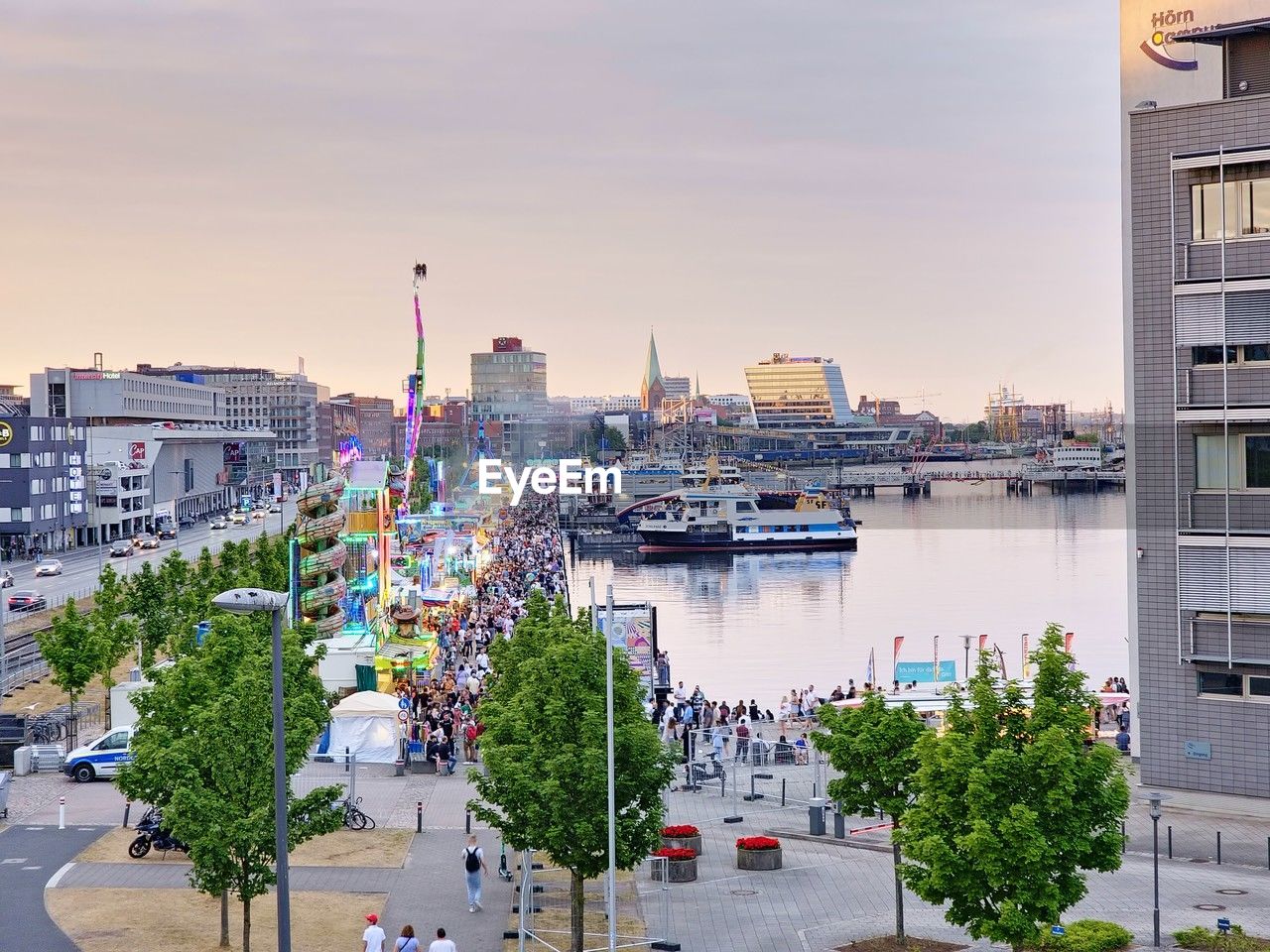 architecture, city, building exterior, built structure, cityscape, urban area, transportation, building, sky, downtown, water, nature, skyline, mode of transportation, street, ship, travel destinations, town, plant, nautical vessel, tree, travel, high angle view, landscape, residential district, urban skyline, motor vehicle, car, neighbourhood, outdoors, metropolitan area, city life, vehicle, business finance and industry, city street, business, road, office building exterior, sunset, residential area, tourism, tower block, walkway, marina, no people, dock, skyscraper