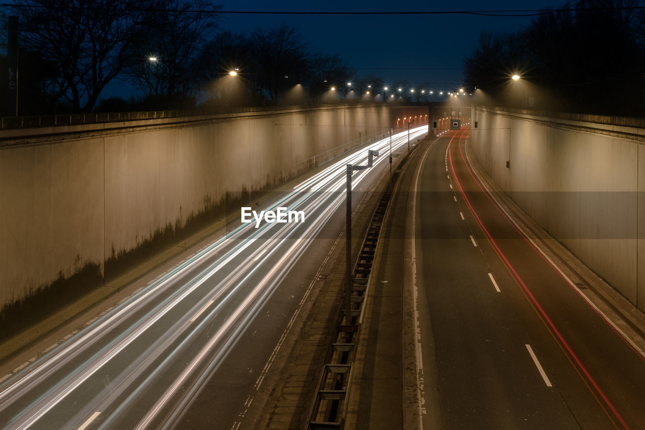 High angle view of light trails on highway at night