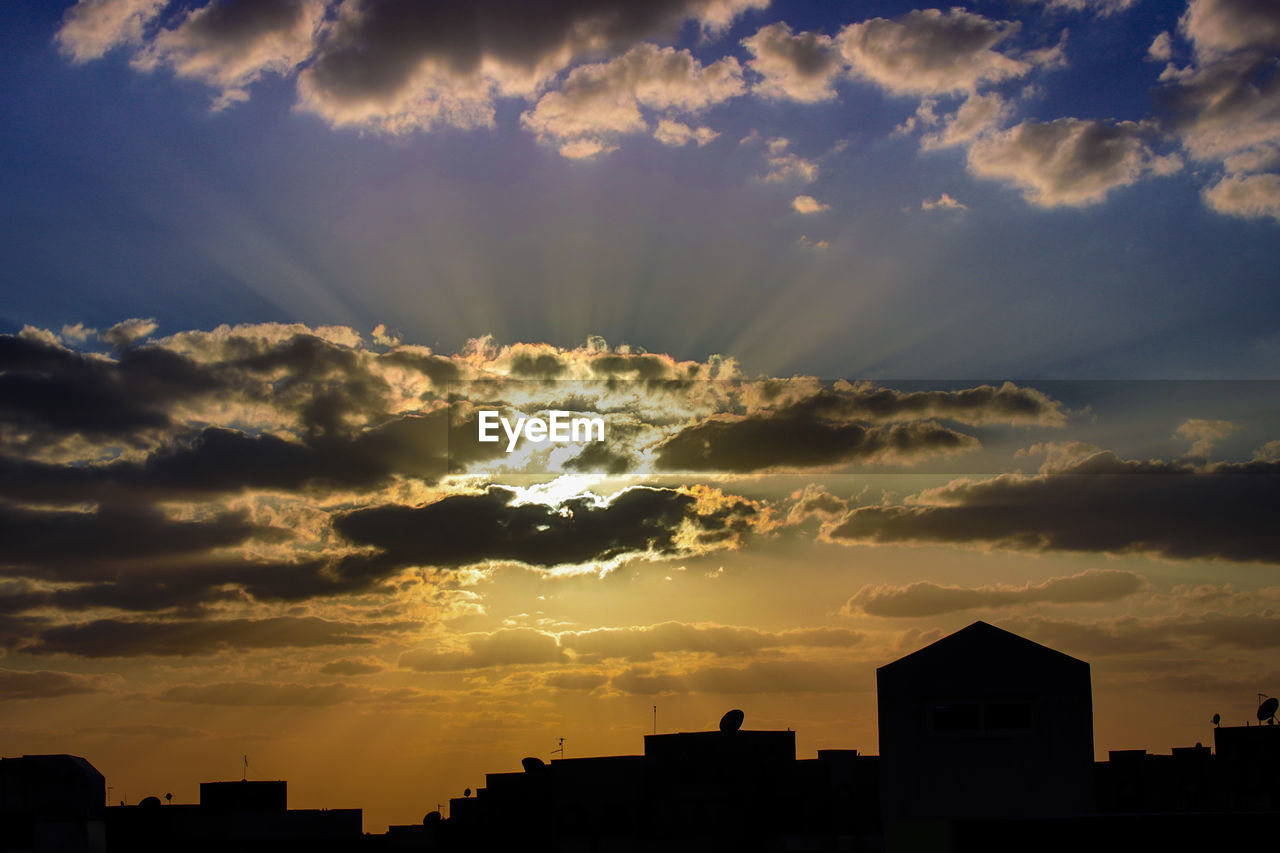 Silhouette buildings against sky during sunset