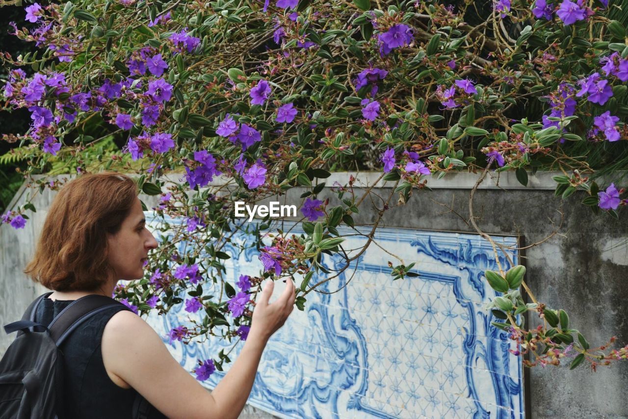 Woman touching purple flowers