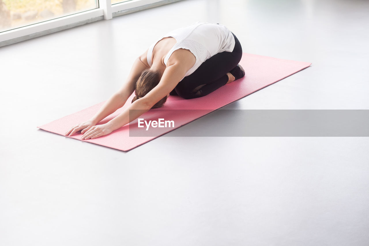 High angle view of woman relaxing on table