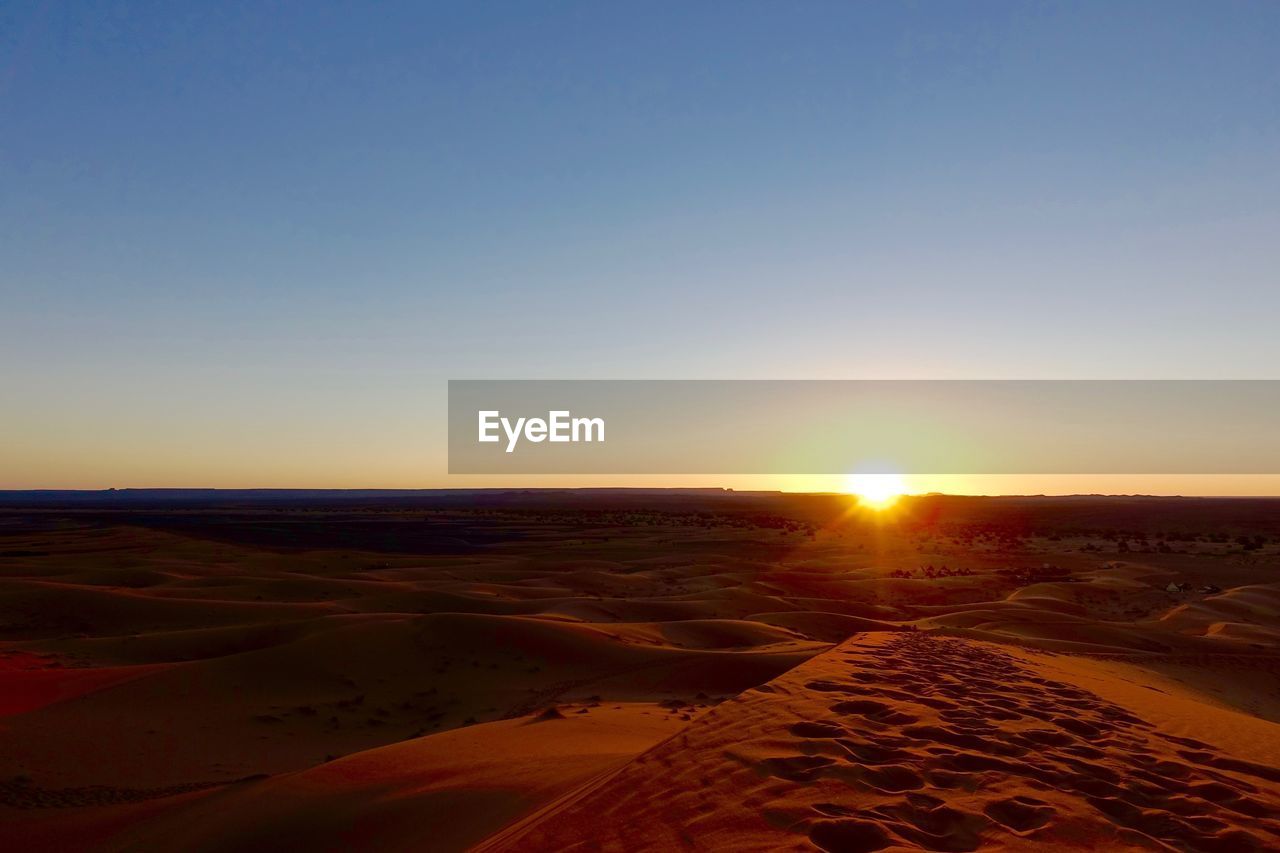 Scenic view of sunset over beach