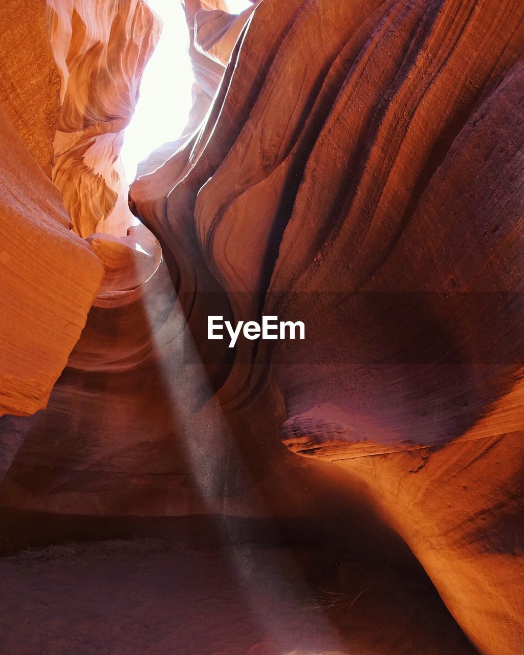 Low angle view of rock formations at lower antelope canyon during sunny day