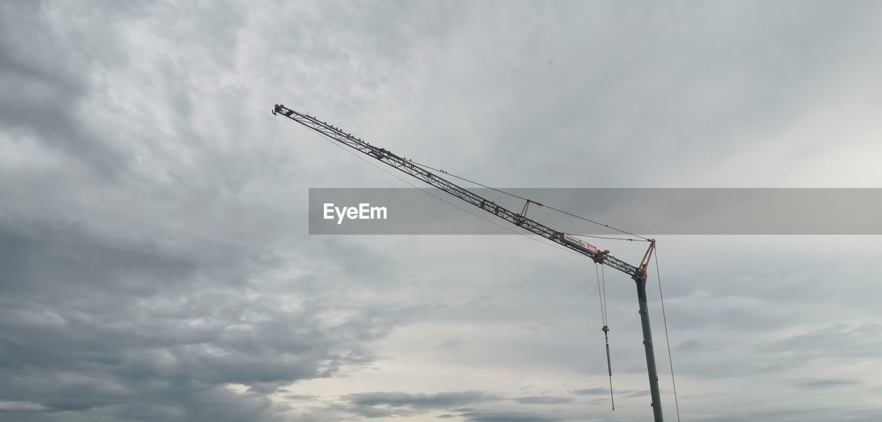 cloud, sky, crane - construction machinery, machinery, nature, construction industry, industry, low angle view, no people, construction site, wind, outdoors, mast, development, overcast, day, architecture, line, construction machinery