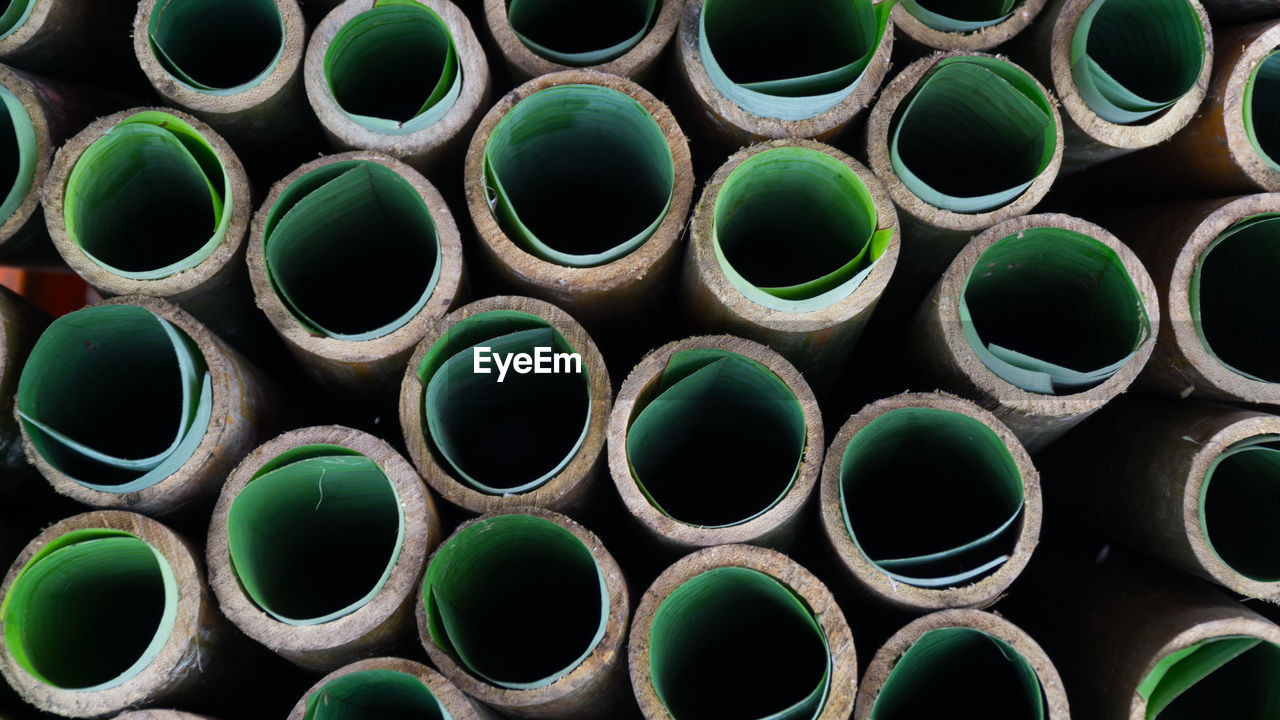 FULL FRAME SHOT OF STACK OF PIPE