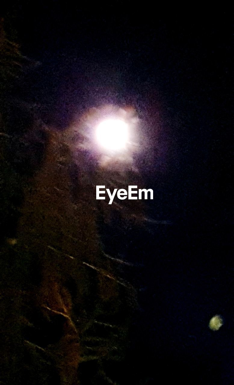 LOW ANGLE VIEW OF ILLUMINATED MOON AGAINST SKY