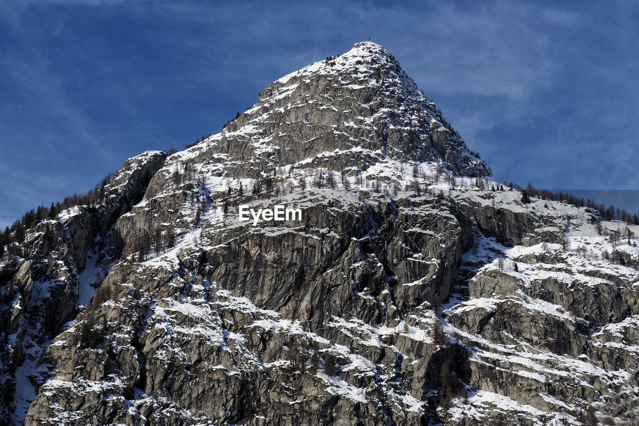 Low angle view of snowcapped mountain against sky