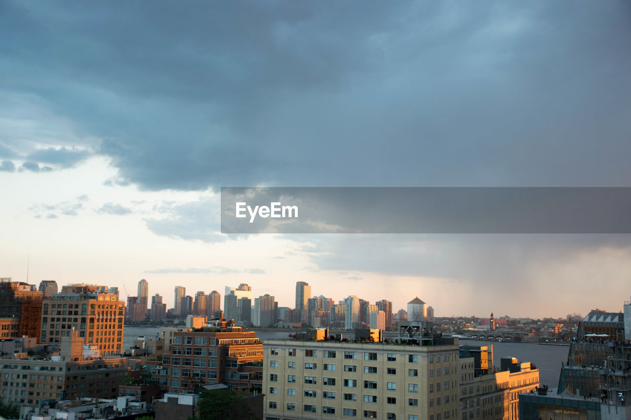 Cityscape against cloudy sky