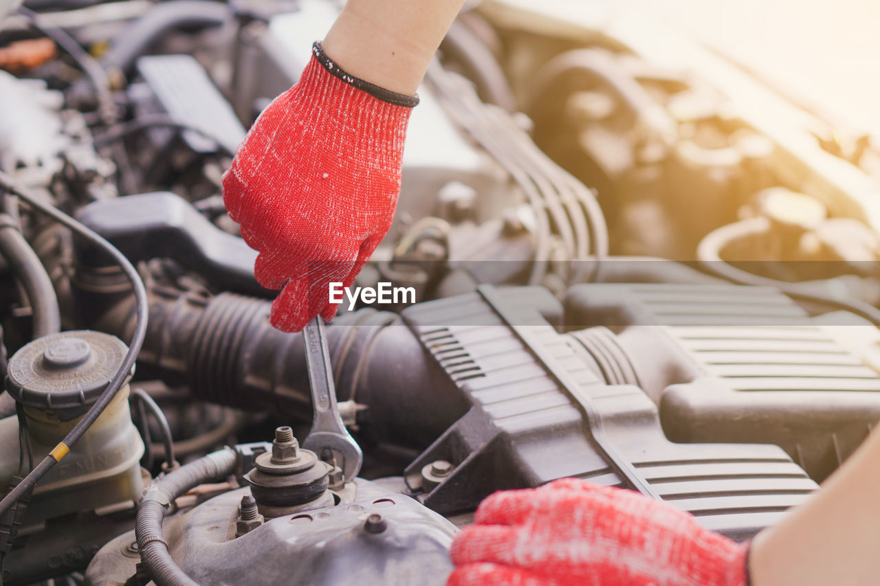 CLOSE-UP OF HANDS WORKING IN VEHICLE
