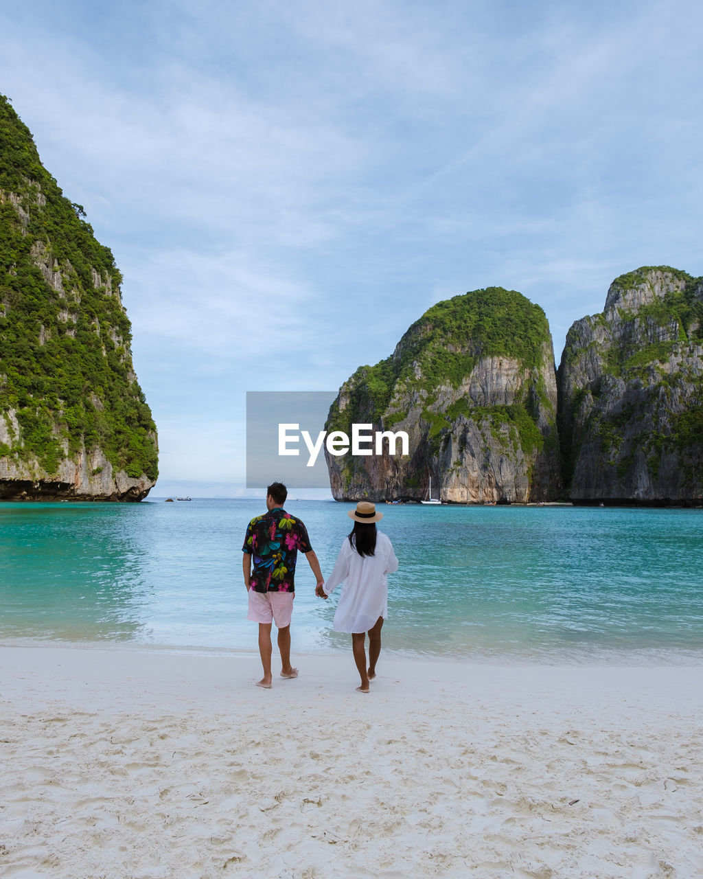 rear view of woman standing at beach