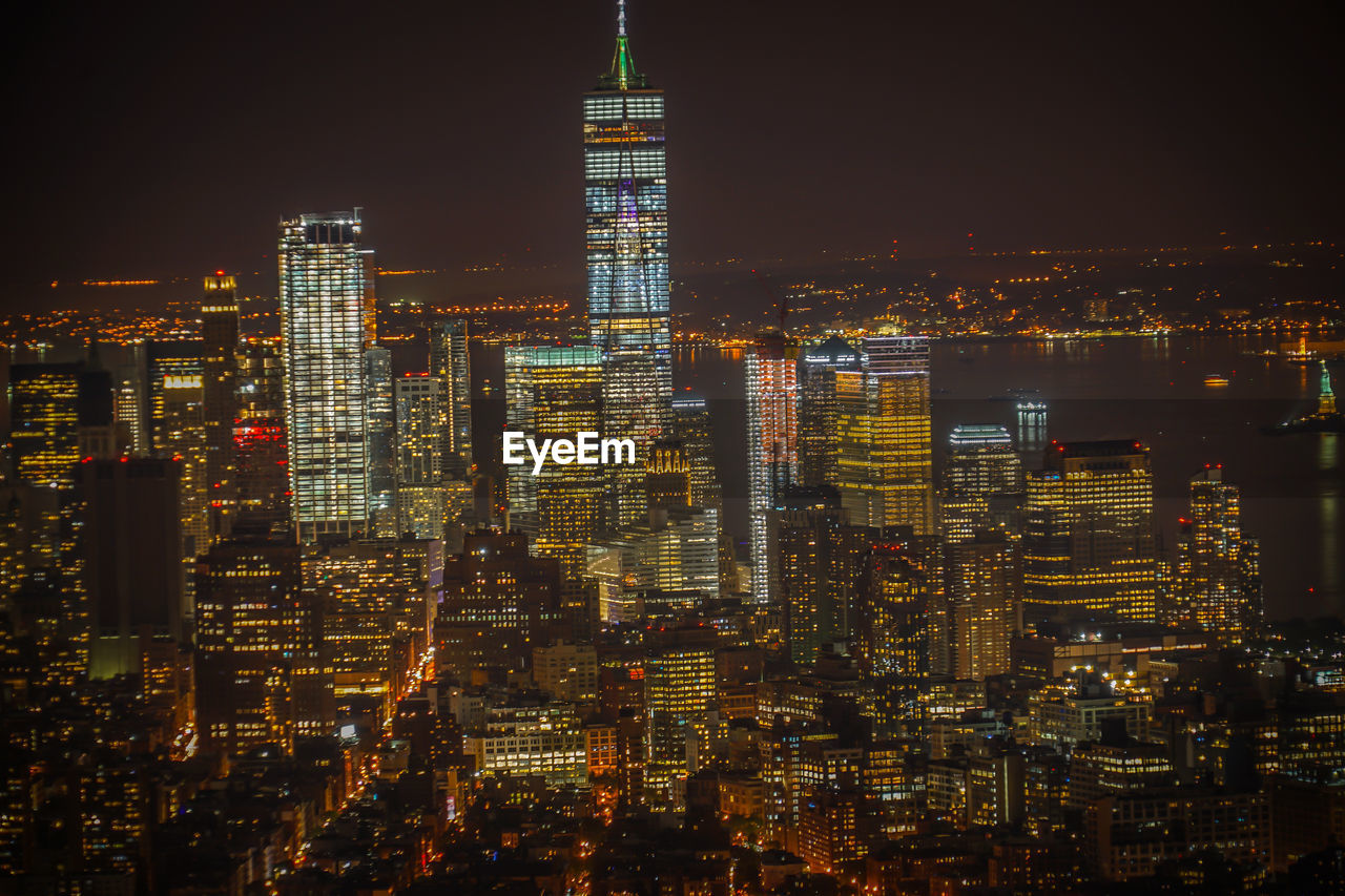 ILLUMINATED BUILDINGS AGAINST SKY AT NIGHT