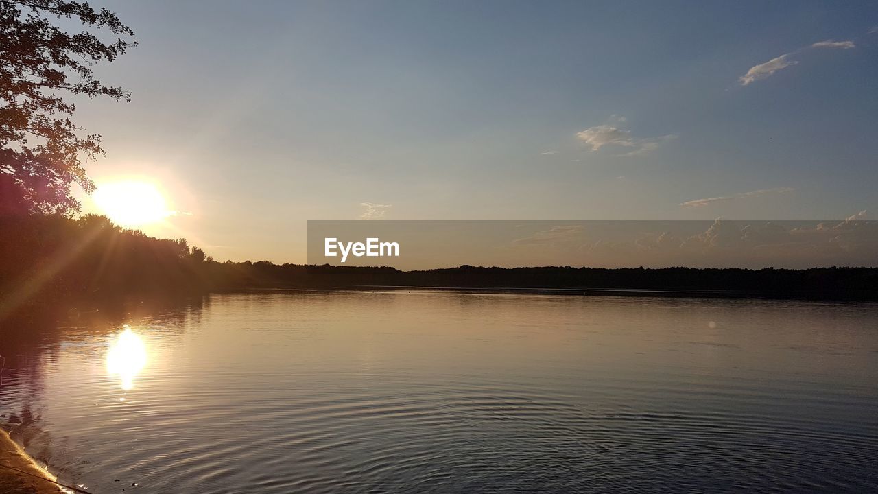 VIEW OF LAKE AGAINST SKY DURING SUNSET