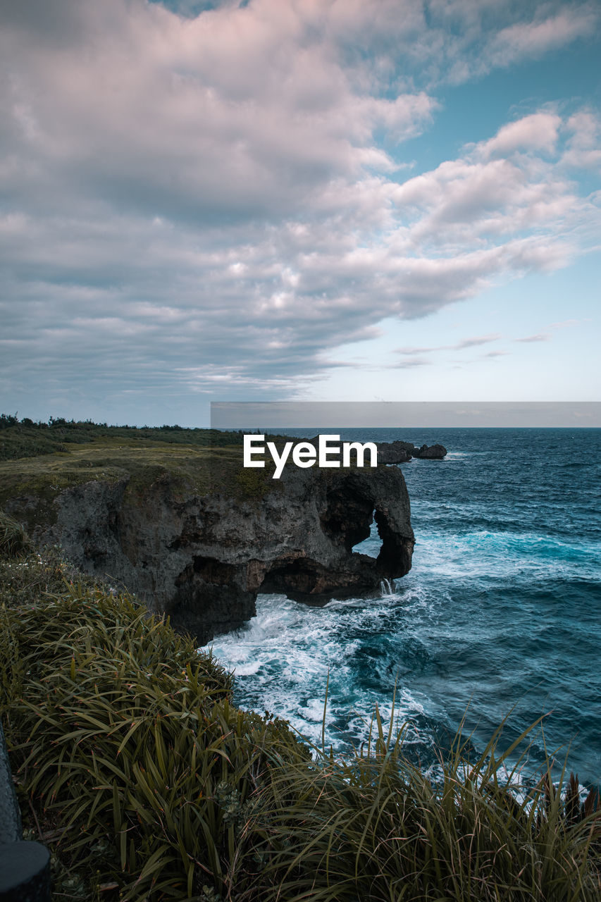 SCENIC VIEW OF SEA AND ROCKS AGAINST SKY