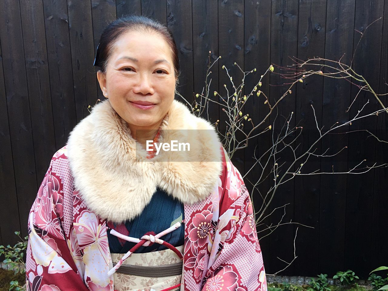 Portrait of smiling woman standing at kiyomizu-dera