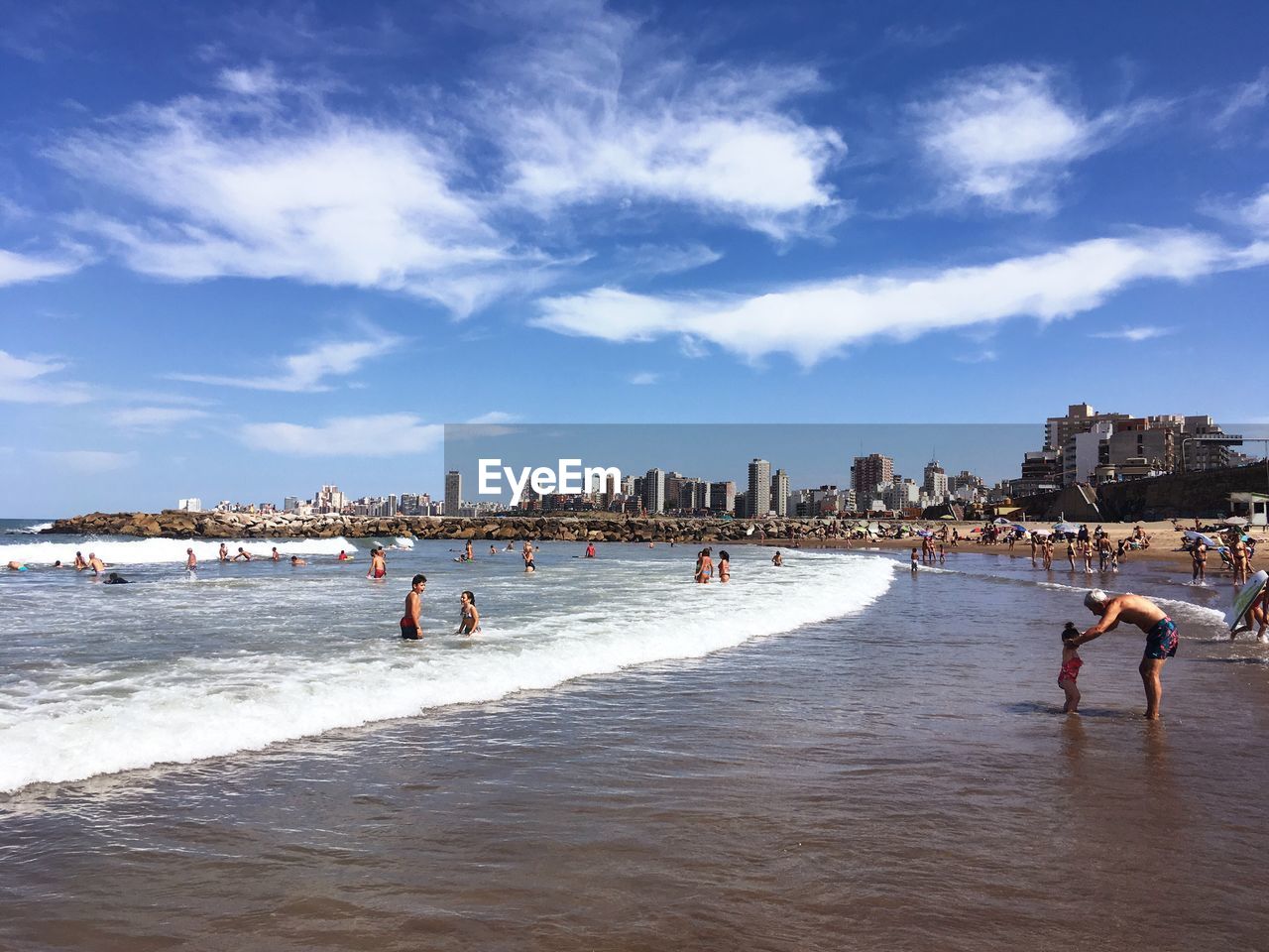 PEOPLE ON BEACH AGAINST SKY