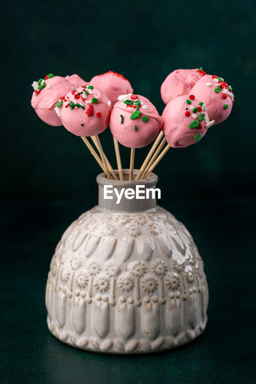 Homemade cake pops in a vase on the table