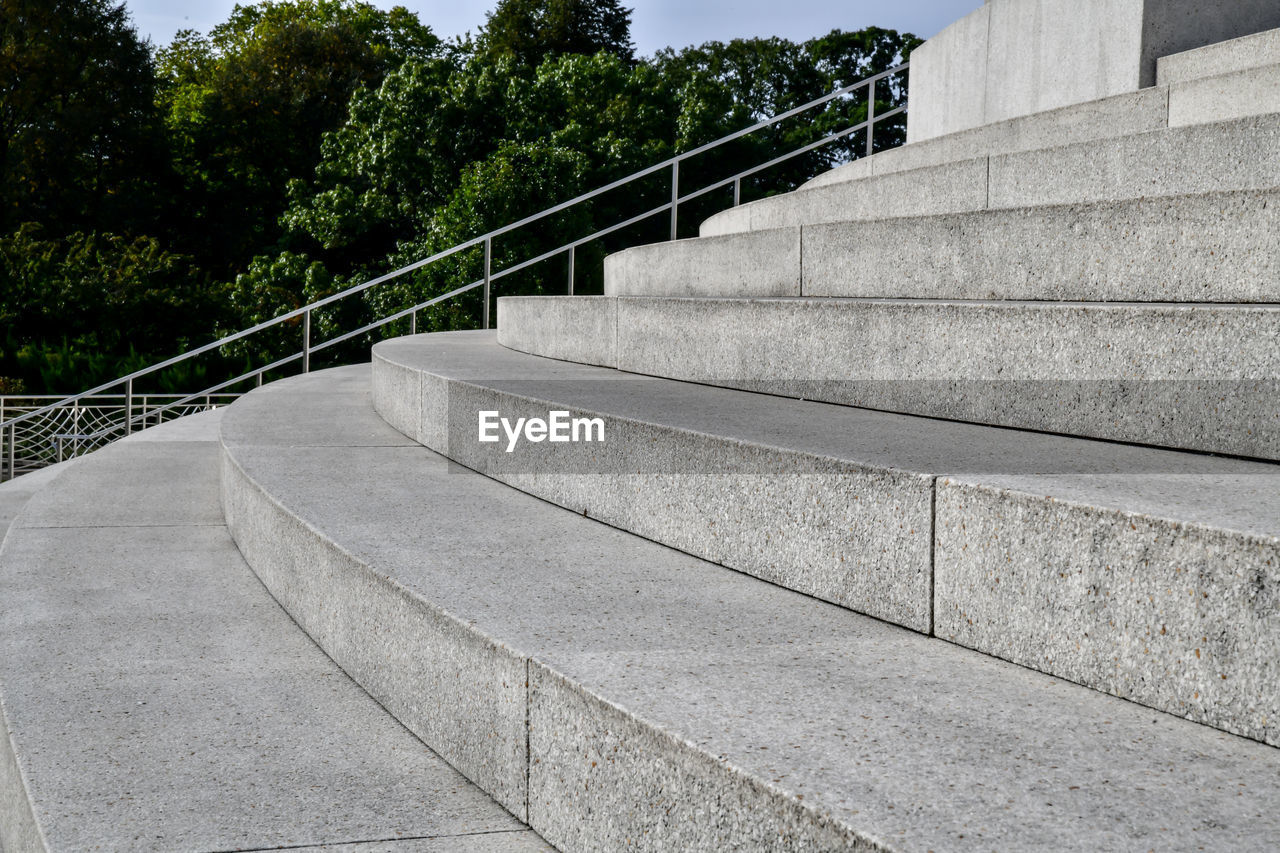 Staircase by trees against sky