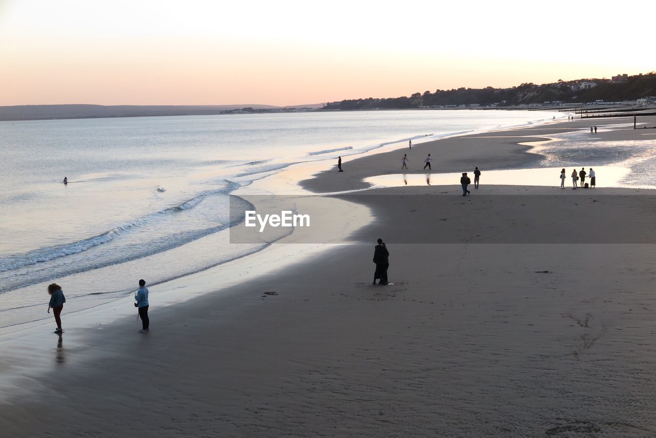 PEOPLE AT BEACH DURING SUNSET