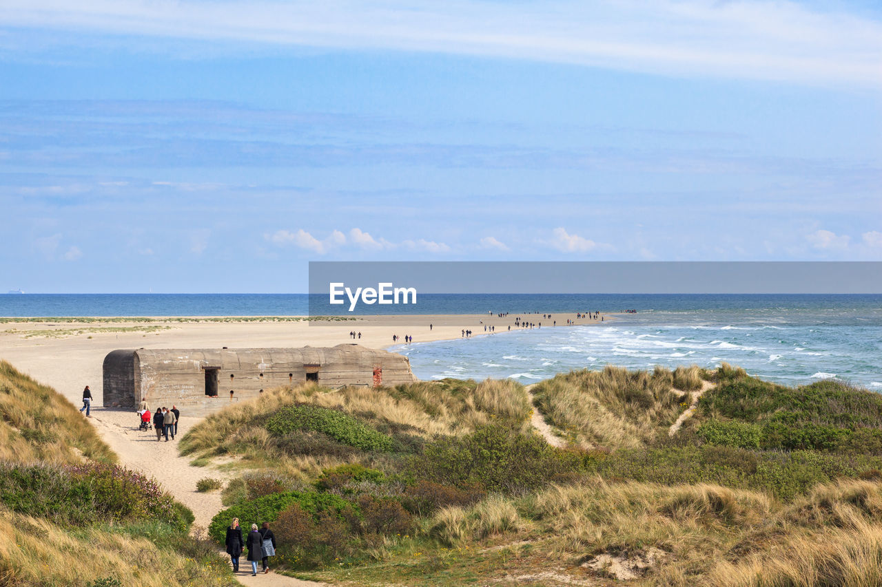 People on beach against sky